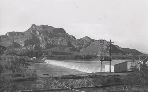 Photo- View of Granite Reef Diversion Dam, power lines and canal in foreground