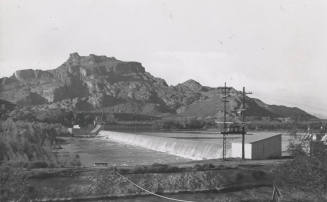 Photo- View of Granite Reef Diversion Dam, power lines and canal in foreground