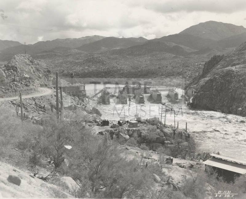 Photo-View of a flooded Verde River showing partial construction of Bartlett Dam