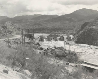 Photo-View of a flooded Verde River showing partial construction of Bartlett Dam
