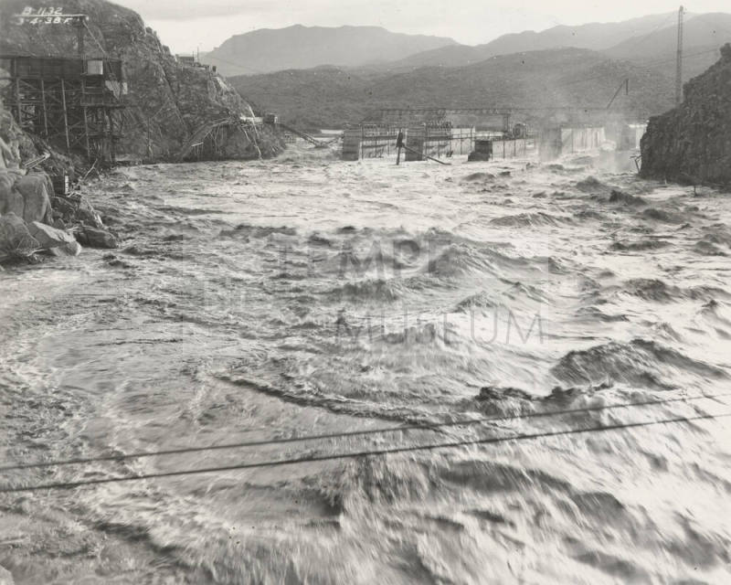 Photo-View of a flooded Verde River showing partial construction of Bartlett Dam