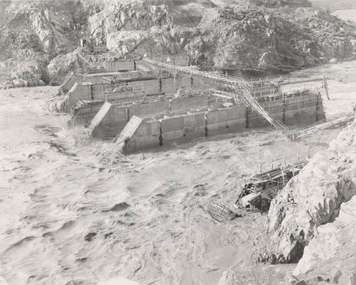Photo-View of a flooded Verde River showing partial construction of Bartlett Dam