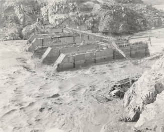 Photo-View of a flooded Verde River showing partial construction of Bartlett Dam