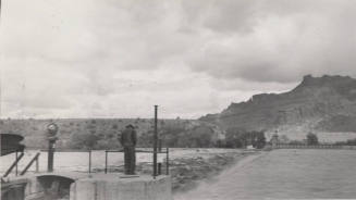 Photo- Man viewing the Salt River flowing over the Granite Reef Diversion Dam
