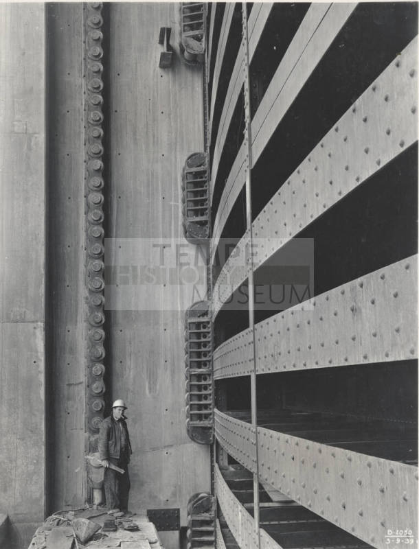 Photo- Worker standing next to the Bartlett Dam spillway gate section