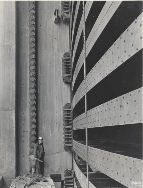 Photo- Worker standing next to the Bartlett Dam spillway gate section