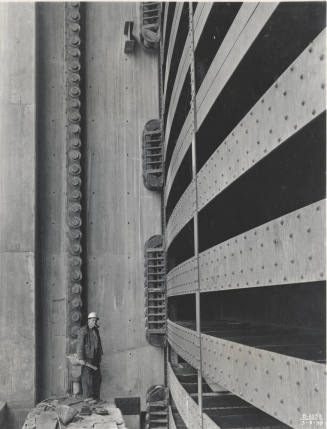 Photo- Worker standing next to the Bartlett Dam spillway gate section