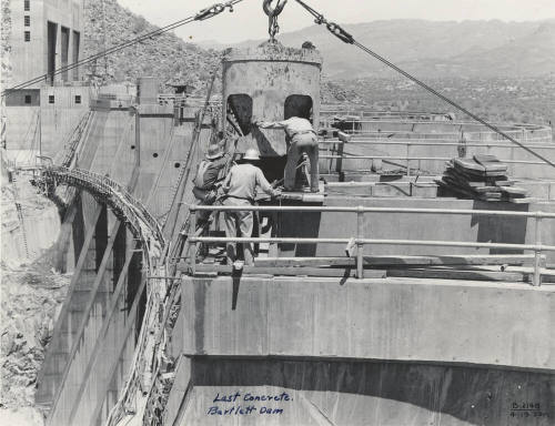 Photo- View of workers finishing the last concrete pour on Bartlett Dam