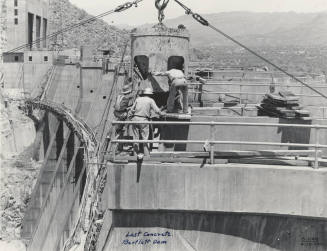 Photo- View of workers finishing the last concrete pour on Bartlett Dam