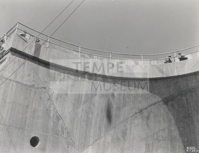 Photo- View of two workers standing on top of Bartlett Dam