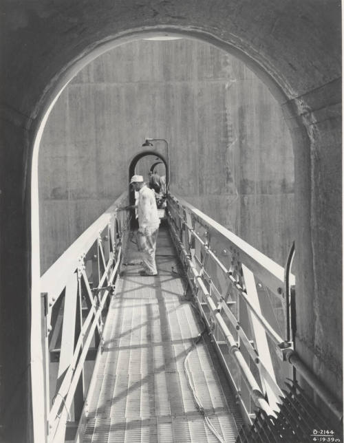 Photo- View of workers painting catwalk on Bartlett Dam