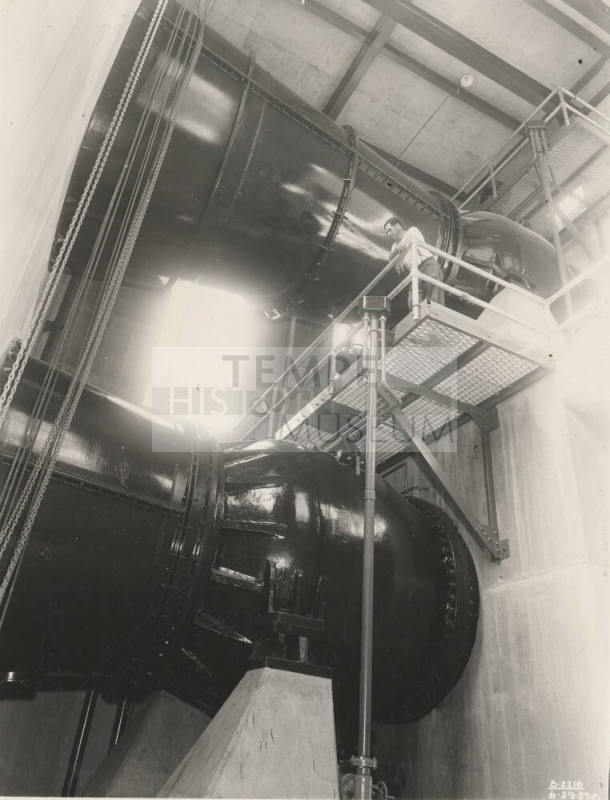 Photo- Interior view of power plant with man working at Bartlett Dam