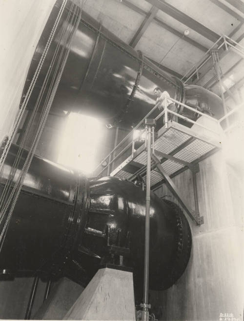 Photo- Interior view of power plant with man working at Bartlett Dam