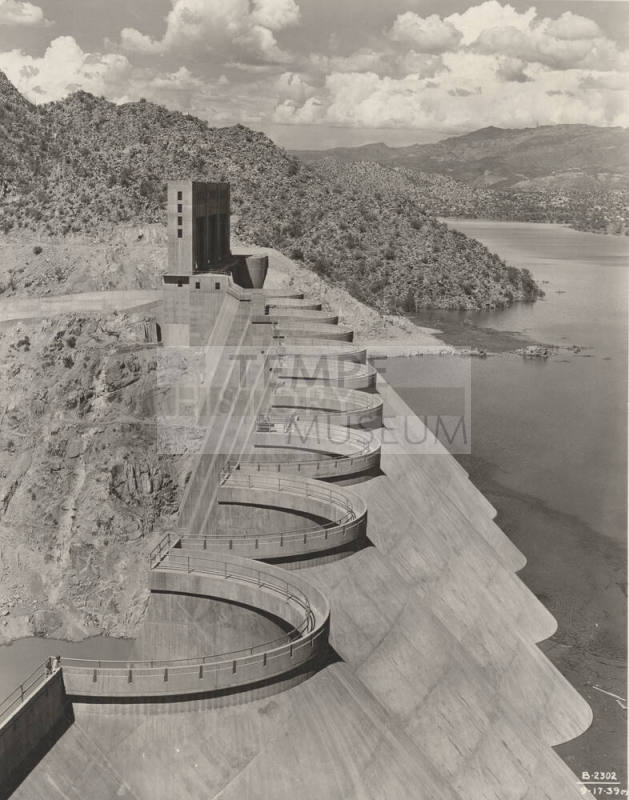 Photo- View of the top of Bartlett Dam with lake filled