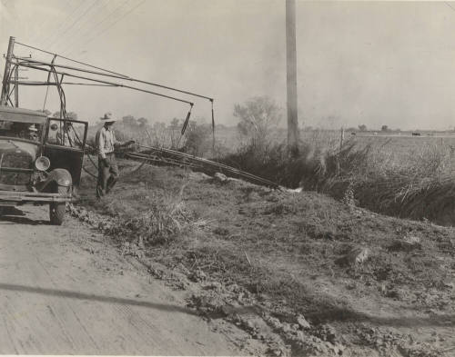 Photo- View of a three man crew with truck burning weeds along side of the road