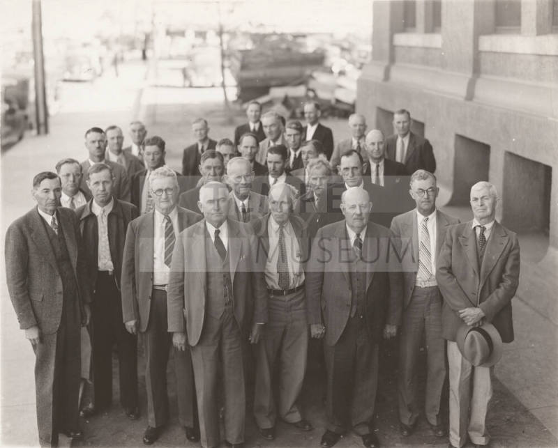 Photo-View of a group of men in front of an unknown building