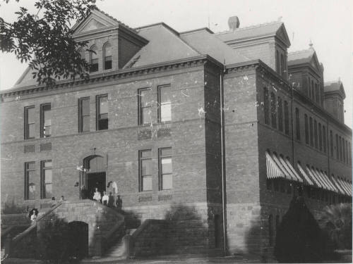 The Geology class of Frederick M. Irish stand on west stairway of  Old Main