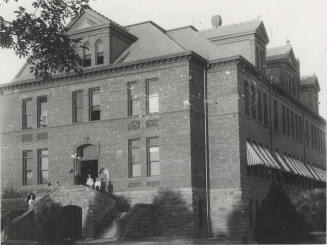 The Geology class of Frederick M. Irish stand on west stairway of  Old Main