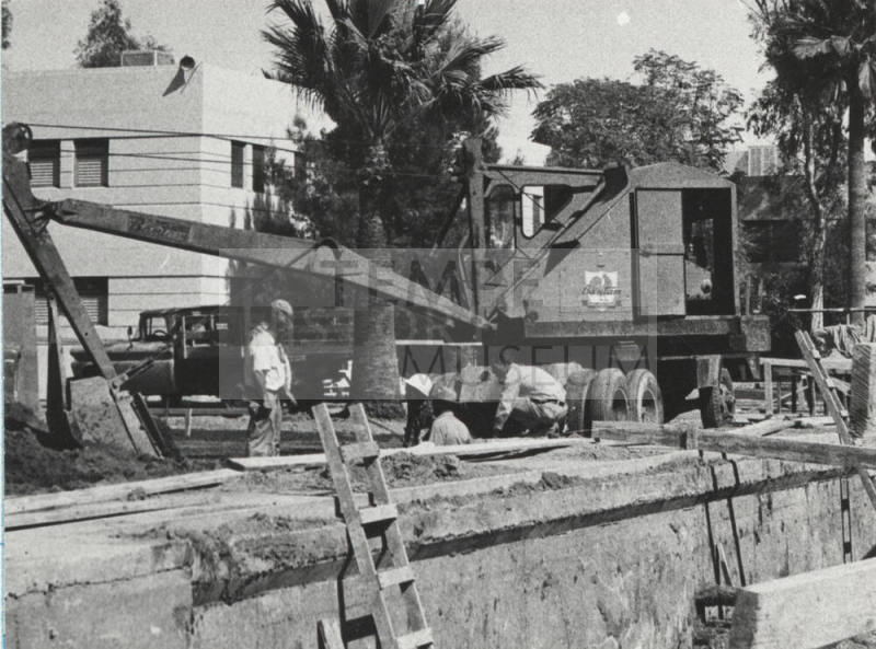 Equipment and men working at construction site at Arizona State University
