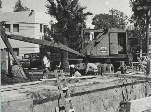 Equipment and men working at construction site at Arizona State University
