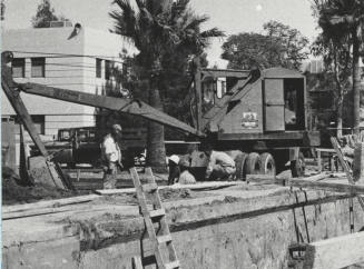 Equipment and men working at construction site at Arizona State University