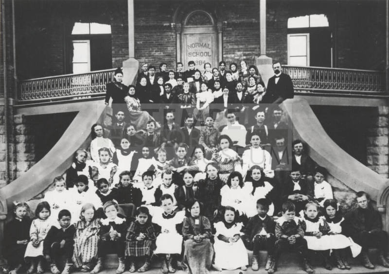 Elementary school children and faculty on "Old Main" front stairs