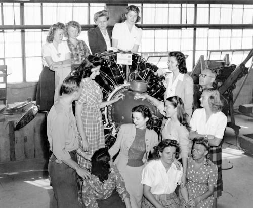 Mrs. Lewis S. Neeb teaches a group about aircraft engine