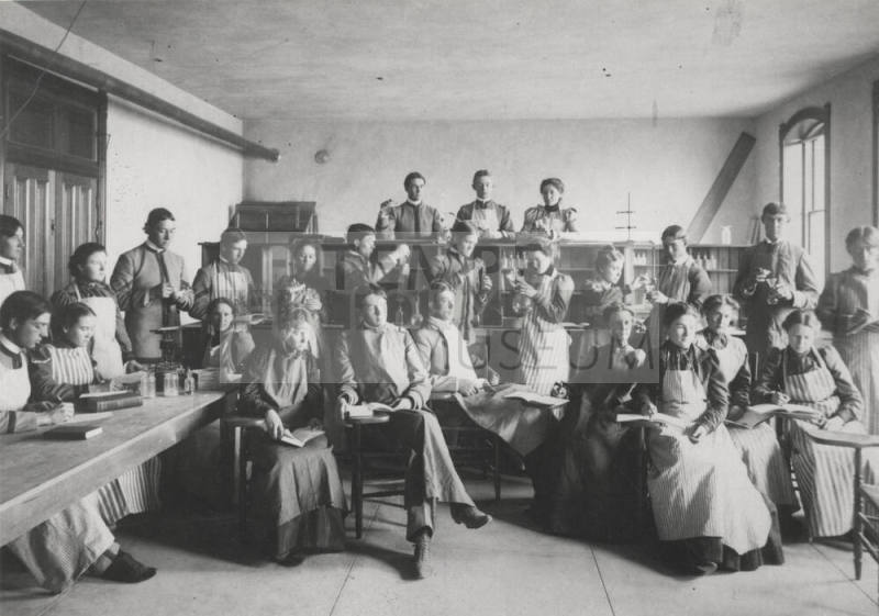 Old Main building with  Frederick M. Irish, Science teacher with Chemistry class