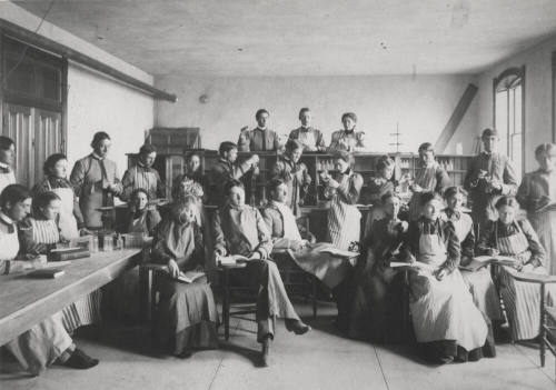 Old Main building with  Frederick M. Irish, Science teacher with Chemistry class