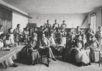 Old Main building with  Frederick M. Irish, Science teacher with Chemistry class