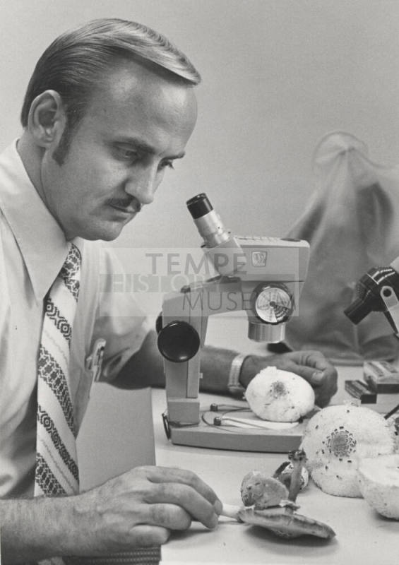 Dr. Chester R. Leathers, Associate Professor of Botany - Microbiology examines