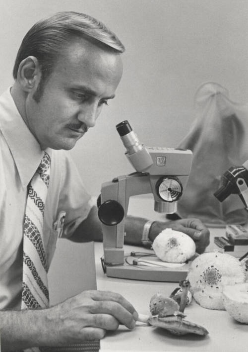 Dr. Chester R. Leathers, Associate Professor of Botany - Microbiology examines