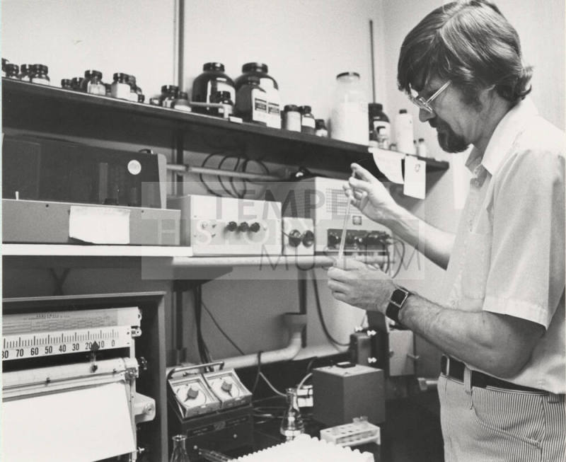 Dr. Allan L. Bieber, Arizona State University Chemistry professor searches for a clue.