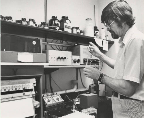 Dr. Allan L. Bieber, Arizona State University Chemistry professor searches for a clue.