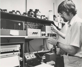 Dr. Allan L. Bieber, Arizona State University Chemistry professor searches for a clue.