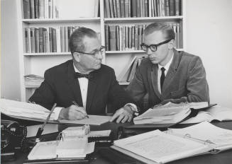 Dr. Arleigh R. Burton, Professor of Accounting, providing extra help to student