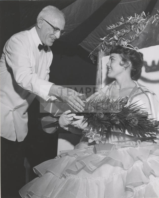 Acting President H. D. Richardson presents roses to Diane Huber