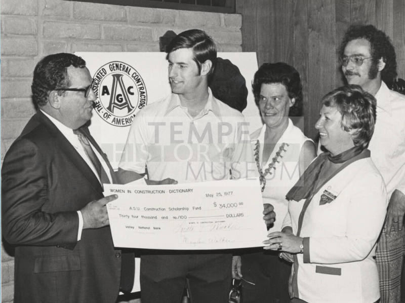 Carl Miller accepts a $34,000 check for the A.S.U. construction scholarship fund