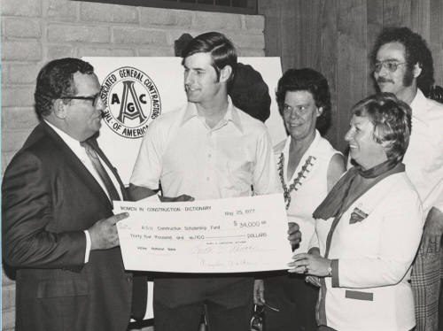 Carl Miller accepts a $34,000 check for the A.S.U. construction scholarship fund
