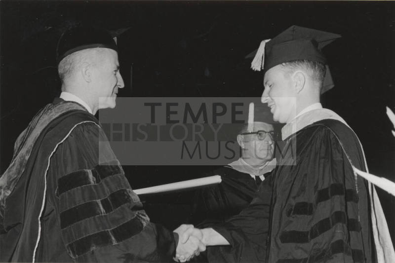 Presentation of diploma by President John W. Schwada to graduate