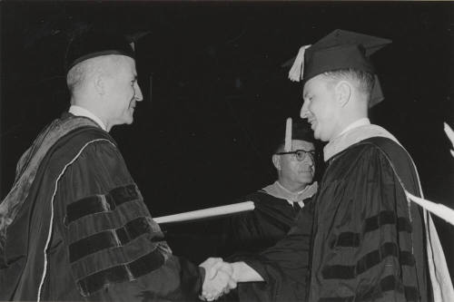 Presentation of diploma by President John W. Schwada to graduate