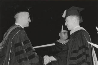 Presentation of diploma by President John W. Schwada to graduate