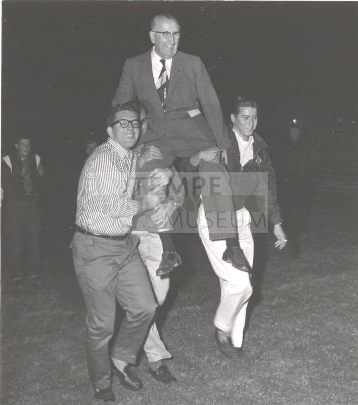 President Gammage is carried on students shoulders in celebration of name change