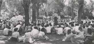 Vice-President H.D. Richardson Greets the Freshman Assembly Held Under the Trees
