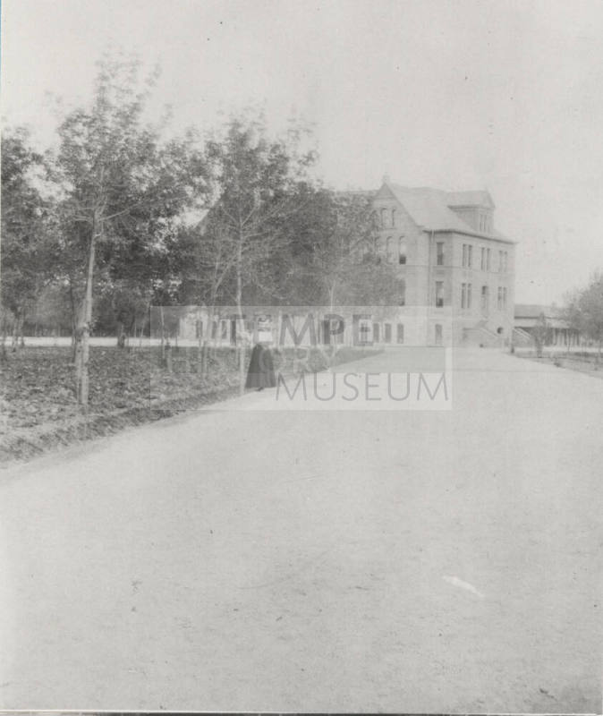 Woman Student Poses on Northwest Drive in Front of Old Main
