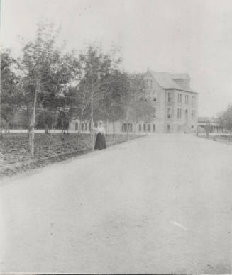 Woman Student Poses on Northwest Drive in Front of Old Main