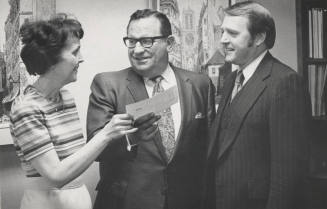 Dr. Miller Receives Check from Vivienne Gardner as Warren Summer Observes