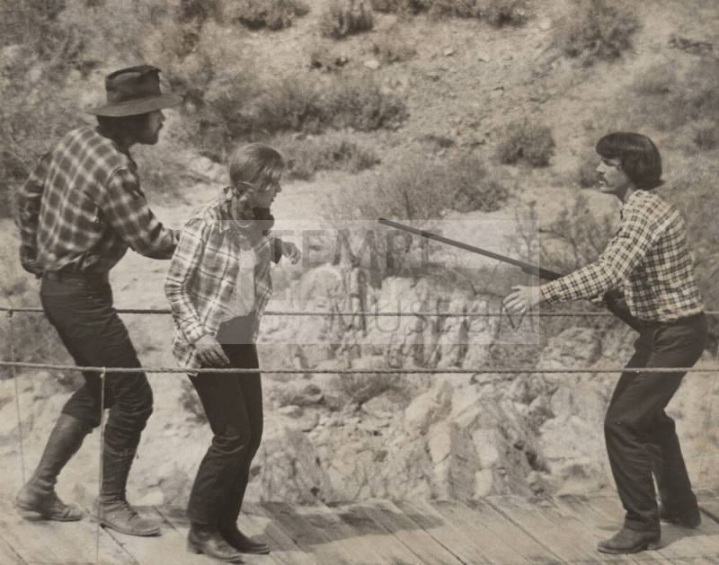 Three Actors on Suspension Footbridge in a Scene from "Blue Jay Summer"