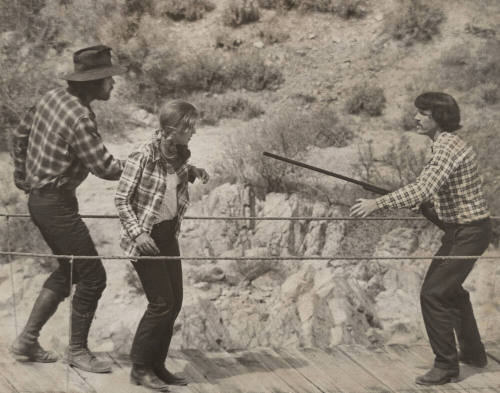 Three Actors on Suspension Footbridge in a Scene from "Blue Jay Summer"