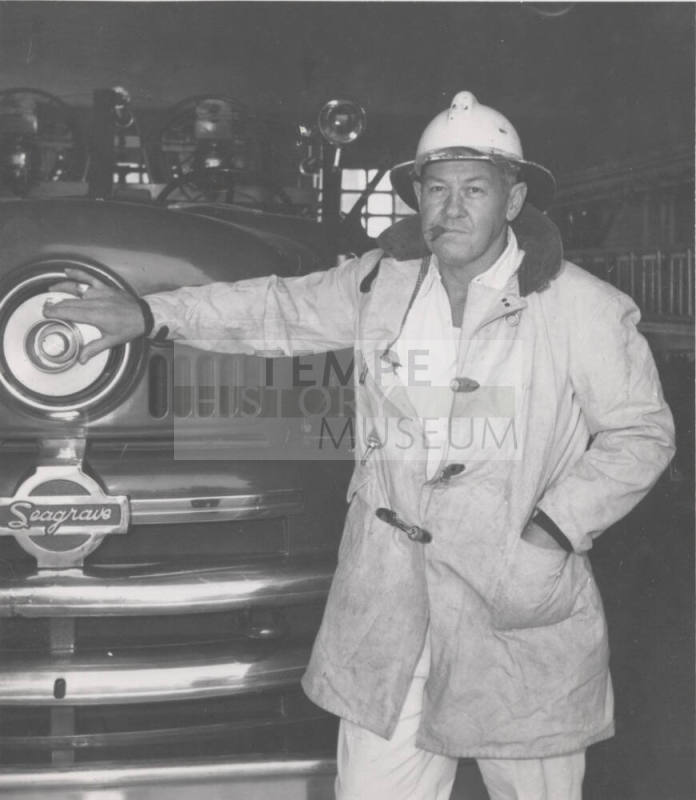 F. Reeves, Tempe Firechief Standing by Fire Engine